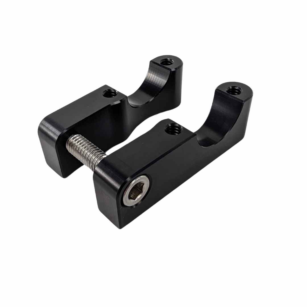 Two black TC Bros. Gauge Relocation Bracket for TC Bros. Pro Series 1" Modular Risers with tightening screws on a white background.
