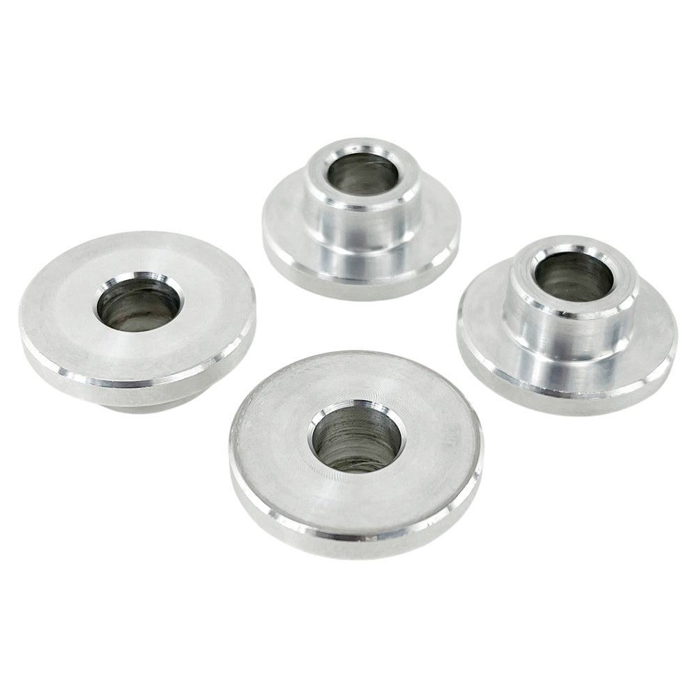 Four round metal TC Bros. Solid Billet Handlebar Riser Bushings isolated on a white background.