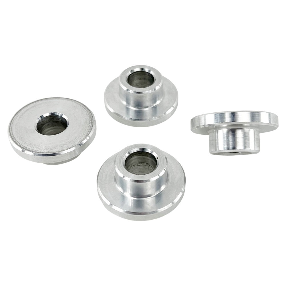 Four round metal TC Bros. Solid Billet Handlebar Riser Bushings isolated on a white background.