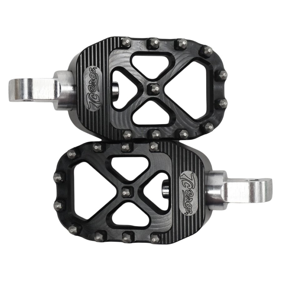 A pair of TC Bros. Pro Series Black MX Foot Pegs on a white background, providing high traction and stability for the Harley Davidson rider.
