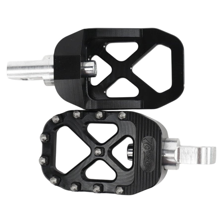 A pair of black TC Bros. Pro Series MX Foot Pegs for Harley Davidson Models on a white background, providing high traction and stability for a Harley Davidson rider.