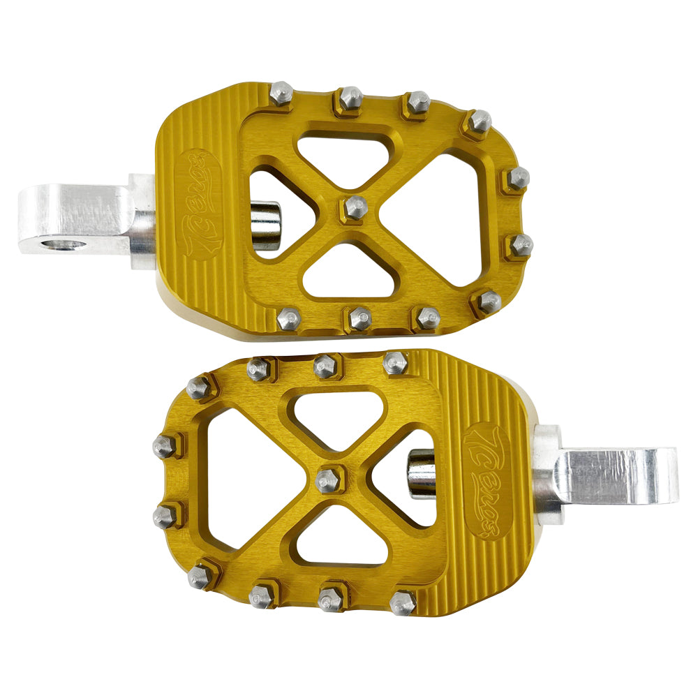 A pair of gold TC Bros. Pro Series Gold MX Foot Pegs for Harley Davidson Models, perfect for Harley Davidson riders seeking high traction.