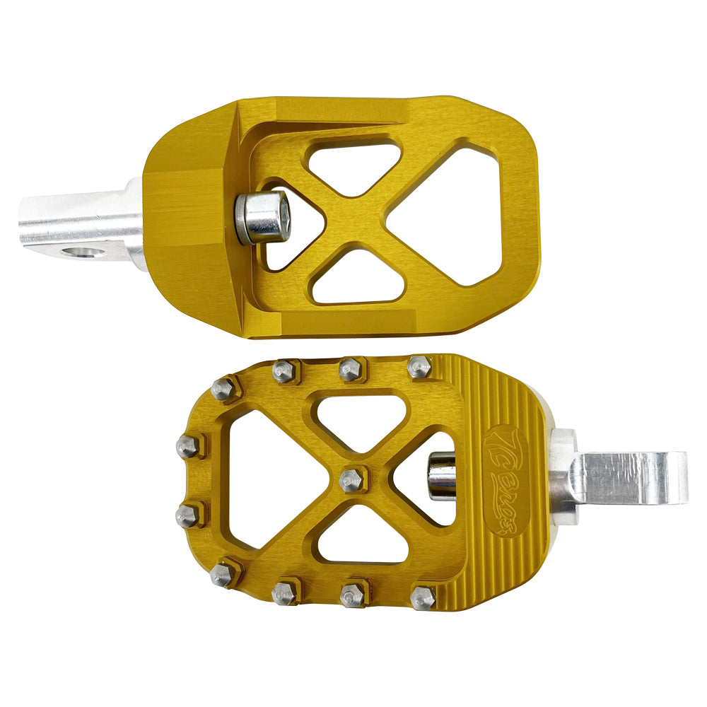 A pair of gold TC Bros. Pro Series Gold MX Foot Pegs for Harley Davidson Models, perfect for Harley Davidson riders seeking high traction.