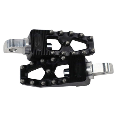 A pair of TC Bros. Pro Series Black MX Lite Foot Pegs, providing high traction and stability for a Harley Davidson rider, on a white background.