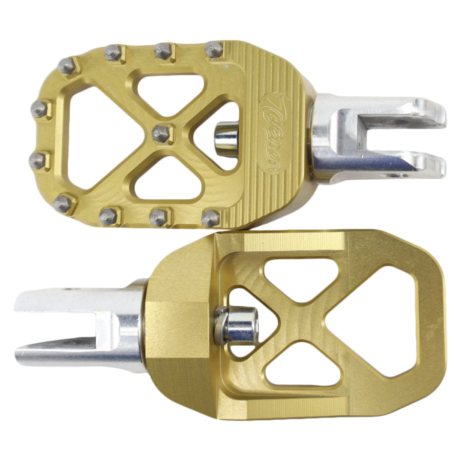 A pair of TC Bros. Pro Series Gold MX Rider Foot Pegs with high traction and stability on a white background.