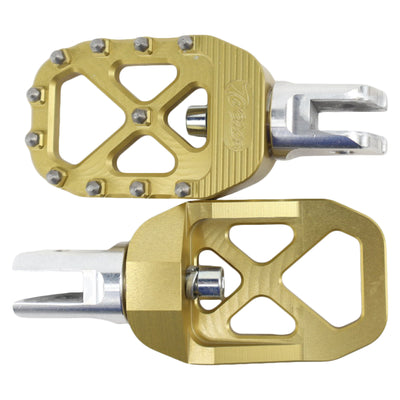 A pair of TC Bros. Pro Series Gold MX Rider Foot Pegs with high traction and stability on a white background.