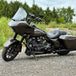 The TC Bros. Front Crash Bar mounting kit for 2014-2023 Harley-Davidson Touring includes bolts and spacers, shown above a motorcycle image—ideal for front engine guard or crash bar installation.