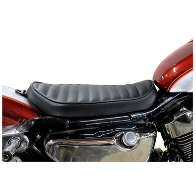 A close up image of a Bates Solo Seat - Tuck and Roll Style - Black 1982-2003 Sportster on a motorcycle.