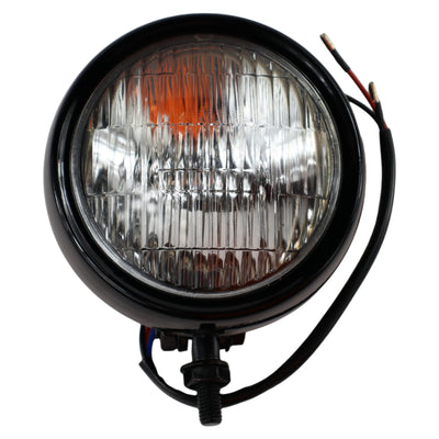 A Moto Iron® 4" Chopper Headlight - Black Clear Lens with powerful illumination and a white background.