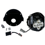 The Shark Demonâ„¢ 2 Performance LED Headlight Kit by Custom Dynamics is a round, black, DOT compliant headlight with an attached wiring harness and connectors. It also includes a separate mounting bracket with screws and rubber grommets, making it perfect for those seeking a reliable upgrade for their '22-'24 Harley Low Rider ST.