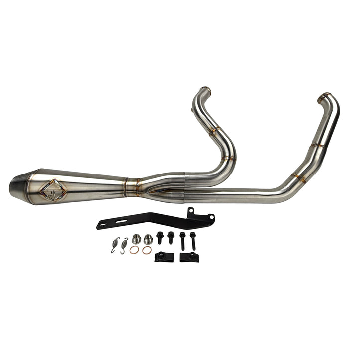 The SP Concepts Big Bore Exhaust M8 Touring FLT 2017-Present - Stainless features a polished stainless steel 2-into-1 design with visible welds and logo, resting on a gray workshop surface with an American flag-themed component in the background.