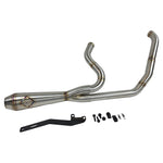 A custom SP Concepts Lane Splitter Exhaust for Harley-Davidson Dyna 1999-2005 lies on a workbench with welded joints; an American flag welding helmet is visible in the background. Stainless construction, ideal for exhaust builds.