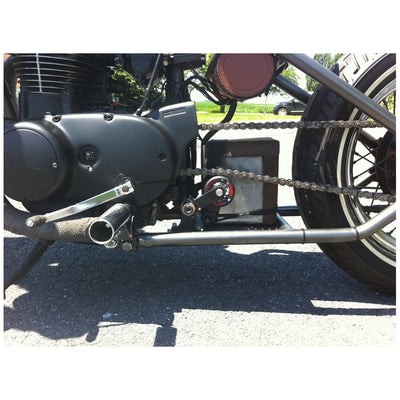 A motorcycle with a 1" Clamp On Chain Tensioner - Skate Wheel (Powell Peralta) installed to maintain the proper tension of the drive chain, provided by Monster Craftsman.
