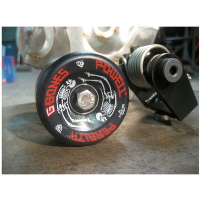 A Bolt On Chain Tensioner - Skate Wheel (Powell Peralta) with a red Monster Craftsman logo on it.