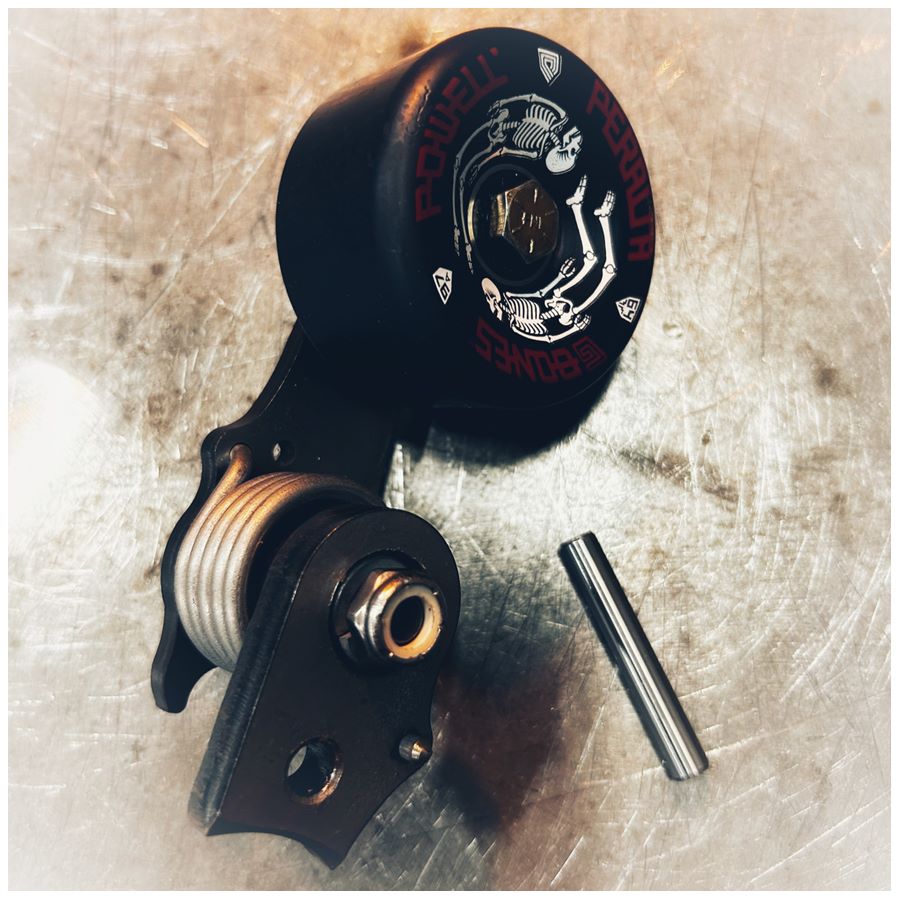 A Single Sided Weld On Chain Tensioner - Skate Wheel (Powell Peralta) with a bolt and nut, used to tighten the tensioner.
