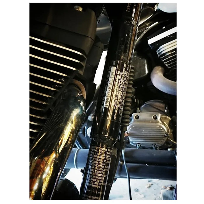 A close up of a motorcycle engine with an Invisivin Magnetic Vin Sticker Cover from the 1999-2005 Dyna Stepped frame.