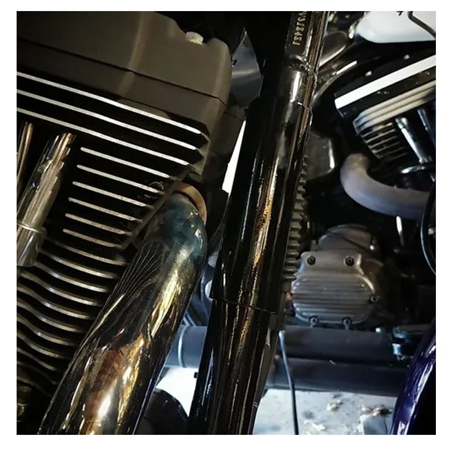 A close up of a motorcycle with an Invisivin Magnetic Vin Sticker Cover - 95-98 Dyna with stepped frame with dual split.