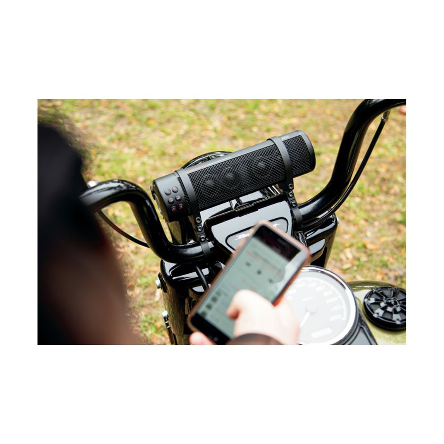 A person is using a Road Thunder Sound Bar Plus by MTX, equipped with a Bluetooth receiver, on a motorcycle.