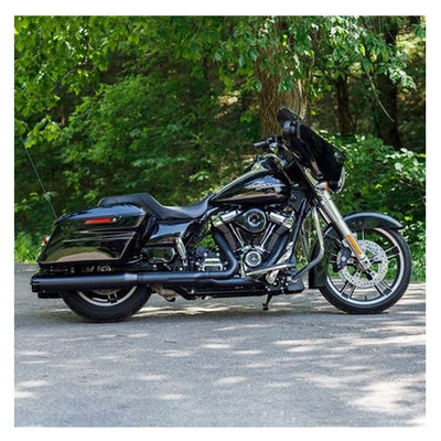 A black motorcycle, with the 50 State Legal - Mk45 TOURING MUFFLER for M8 TOURING MODELS - Black with Black Thruster End Cap from S&S Cycle, is parked on a road in the woods.