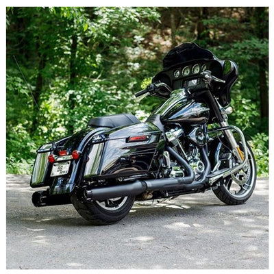 A black motorcycle, with a 50 State Legal Mk45 TOURING MUFFLER for M8 TOURING MODELS - Black with Black Tracer End Cap by S&S Cycle, parked in the woods.