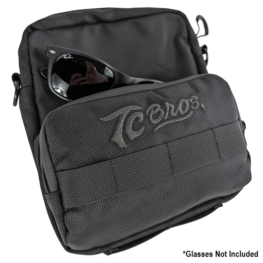 A black TC Bros. Motorcycle Handlebar Bag with a pair of riding essentials.