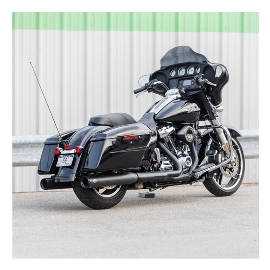 A black motorcycle parked in front of a building, showcasing its 50 STATE LEGAL - GRAND NATIONAL® SLIP-ONS for M8 TOURING MODELS - Black by S&S Cycle.