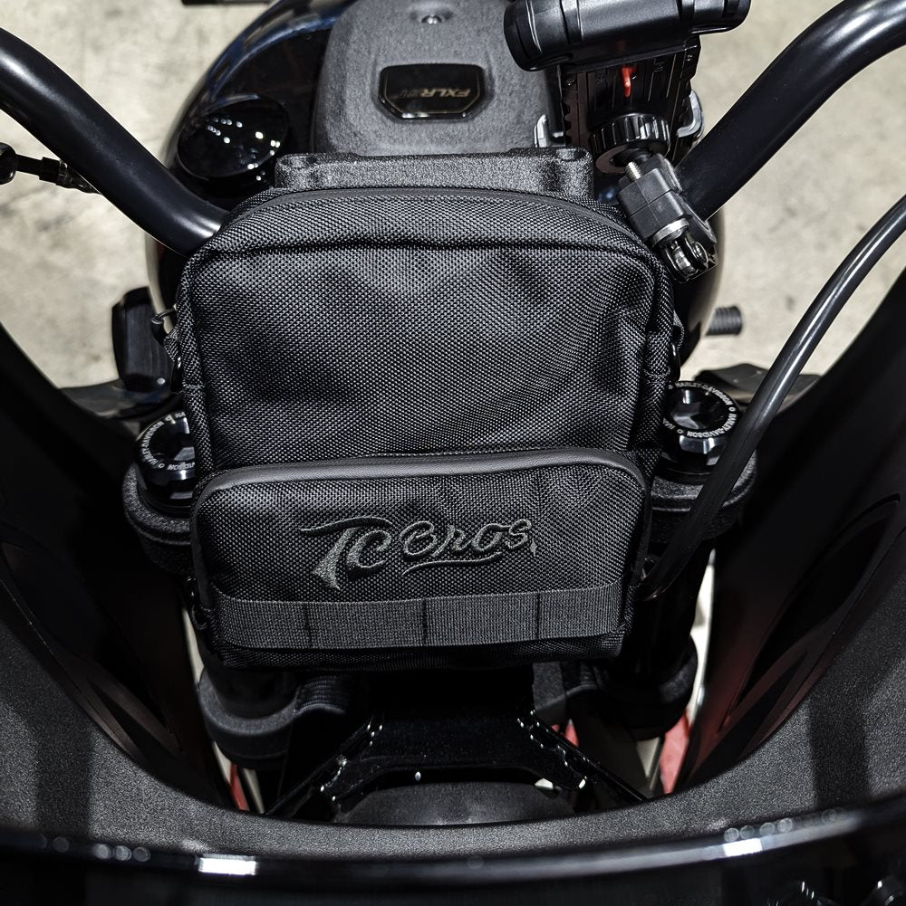 A black TC Bros. Motorcycle Handlebar Bag with a TC Bros. logo on it, perfect for carrying riding essentials.
