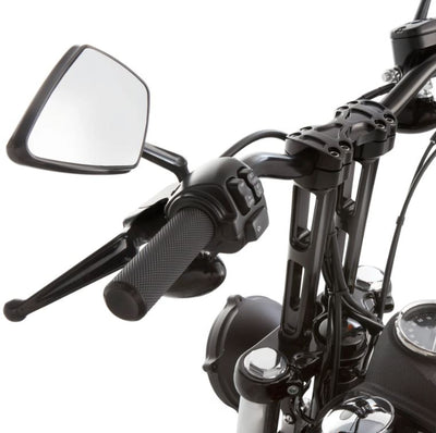 A close up of a black Arlen Ness Fusion Knurled Grips motorcycle handlebar with a mirror.