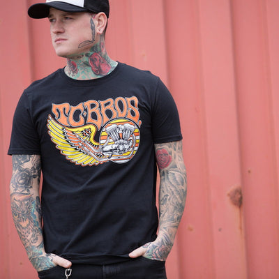 A man wearing a TC Bros. Wing T-Shirt - Black with tattoos.