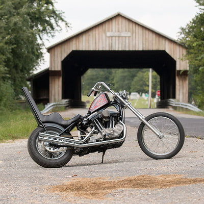 A TC Bros. Extended Fork Tube Kit +6" 39mm for Sportster/ Dyna Narrow Glide parked in front of a covered bridge with Fitment Notes.