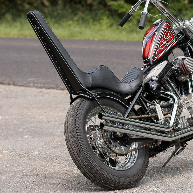 A motorcycle parked on the side of the road with a TC Bros. Tall DIY Sissy Bar Kit.