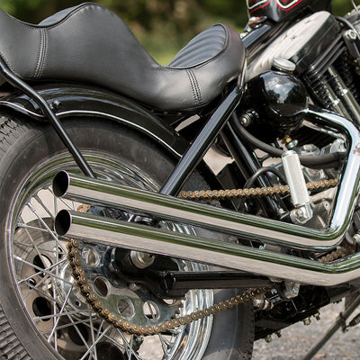 A TC Bros Heavy Duty Oil Tank Mounting Kit For 1982-2003 Sportster Hardtail motorcycle is parked on the side of the road.