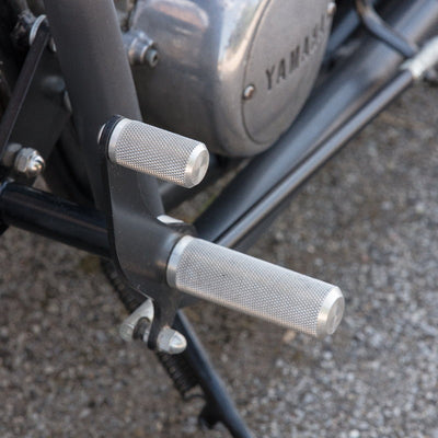 A close up of the handlebars on a TC Bros. Yamaha XS650 Forward Controls Kit motorcycle customized for custom choppers.