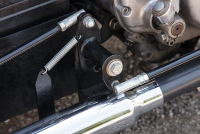 A close up of a TC Bros. motorcycle with a TC Bros. Brake Pivot For Forward Control Linkage.