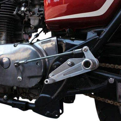 A close up of a XS650 motorcycle with Loaded Gun Custom Yamaha XS650 Rearsets by TC Bros and a chain attached to it.