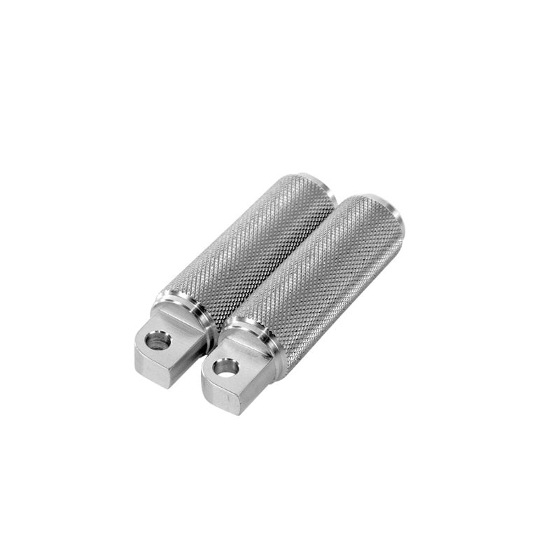 A pair of TC Bros. Nomad Foot pegs for Harley Models - Knurled on a white background.