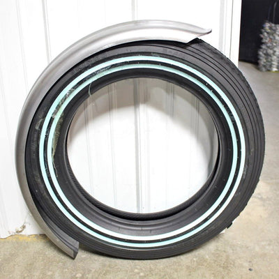 A 5" Wide Raw Steel Ribbed Bobber Fender with high quality Moto Iron® stamped steel construction and a blue stripe on it.