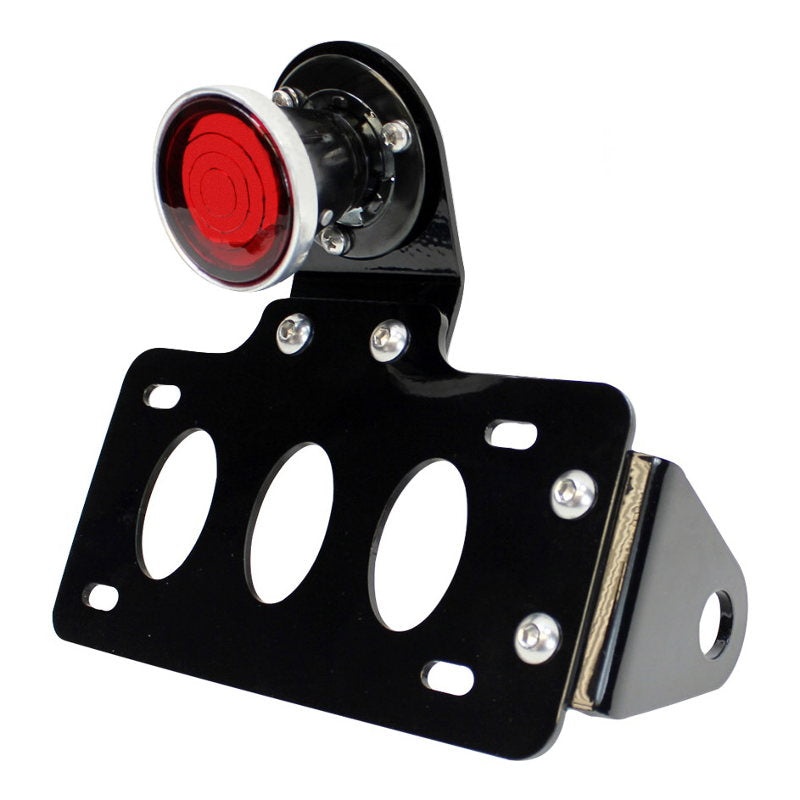 A TC Bros. 2 Inch Round Bobber Side Mount Tail Light/License Plate Bracket with a red light featuring a modular design.