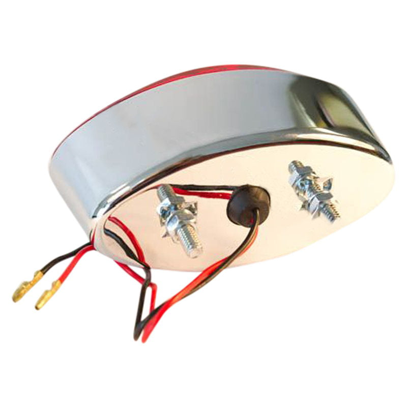An image of a TC Bros. Chrome Cat Eye Tail Light with wires attached to it.