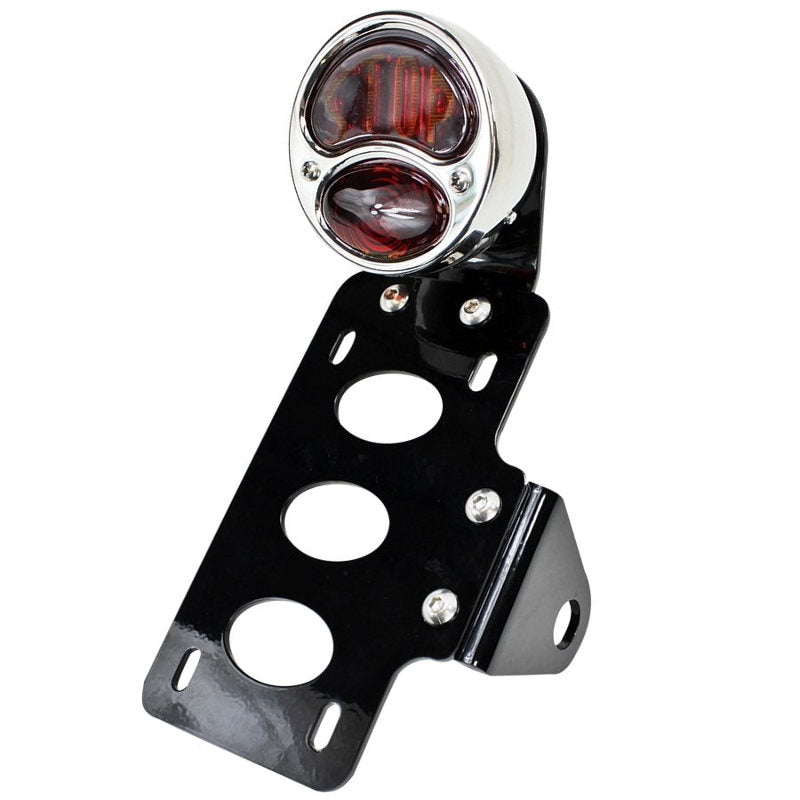 A TC Bros. "Stop" Model A Side Mount Tail Light/License Plate Bracket with a red light and a versatile bracket.