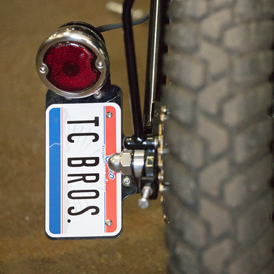 Tc bros license plate with a 33 Ford Replica Tail Light Polished Stainless Steel by TC Bros.