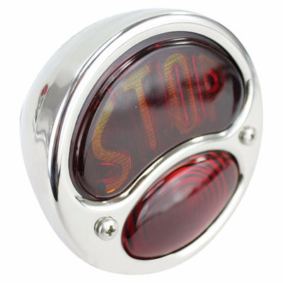 A red "STOP" TC Bros. Ford "Stop" Duolamp Model A Stainless Steel Tail Light with an old school bobber or chopper sign on it.