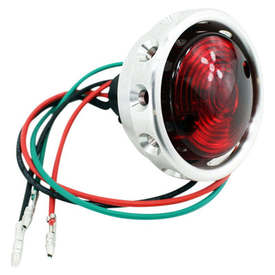 A Mid-USA Aluminum Vintage Drilled Tail Light with wires and connections.