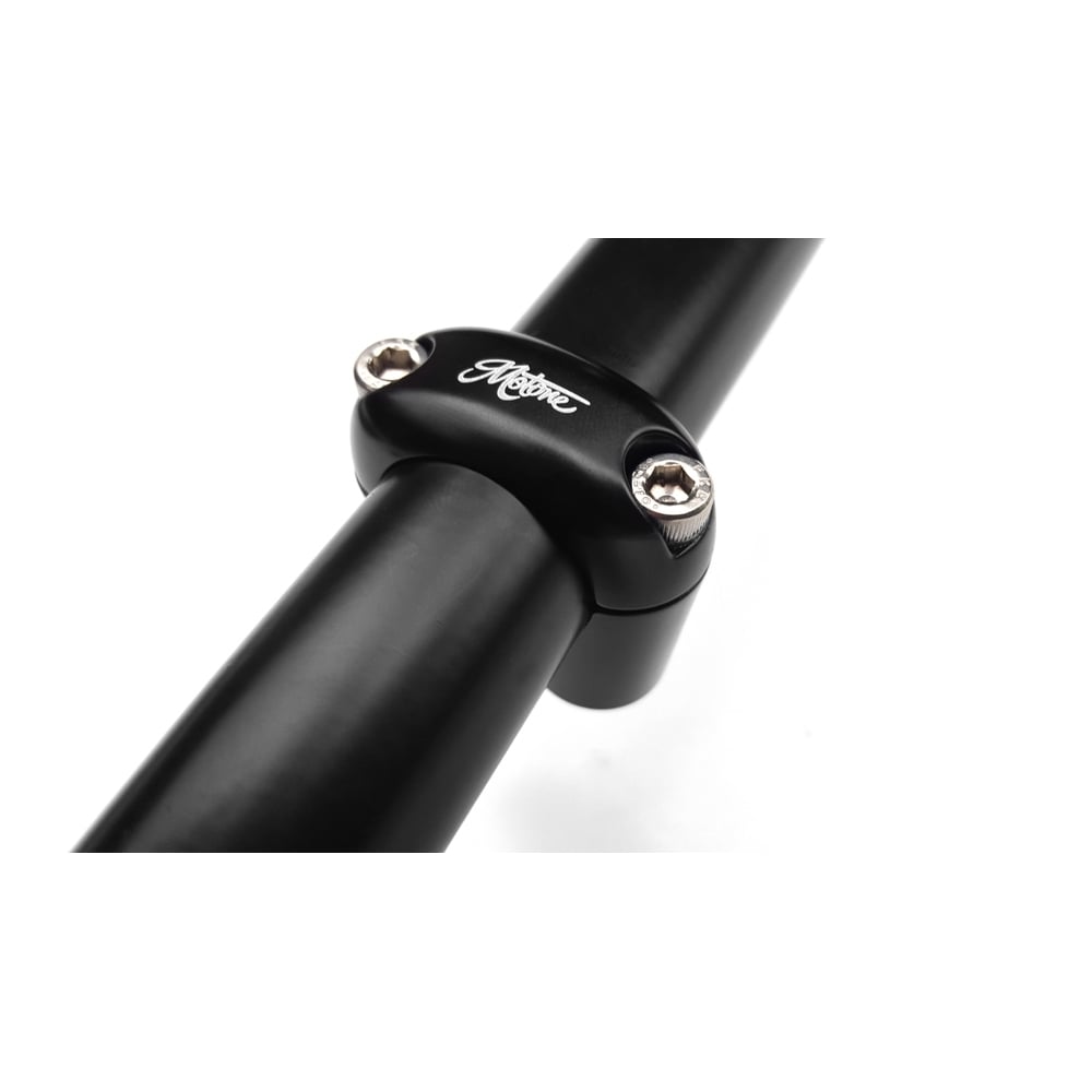 A close up of a bicycle handlebar with Motone motorcycle DUAL BUTTON MICROSWITCH FOR 1" HANDLEBAR - BLACK.