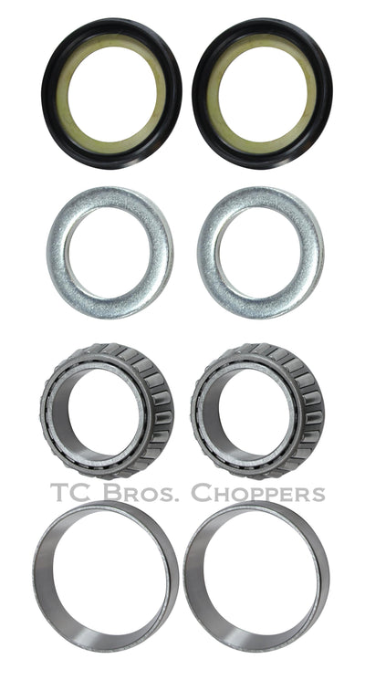 A group of high performance metal objects, including the All Balls Honda CB750 High Performance Steering Head Bearing Kit.