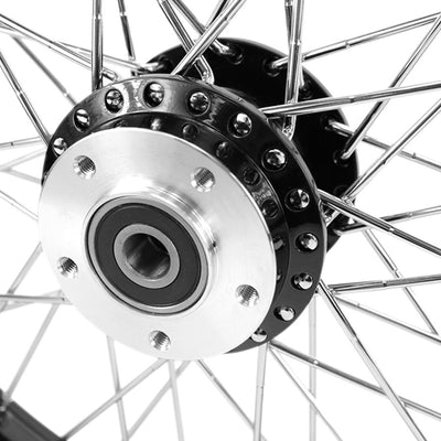 A close up of a Moto Iron® Black Front 40 Spoke Wheel 19 "x 2.15" (fits Harley FXD 2000-03,Sportster 2000-07) Billet Hub belonging to a Harley FXD motorcycle.