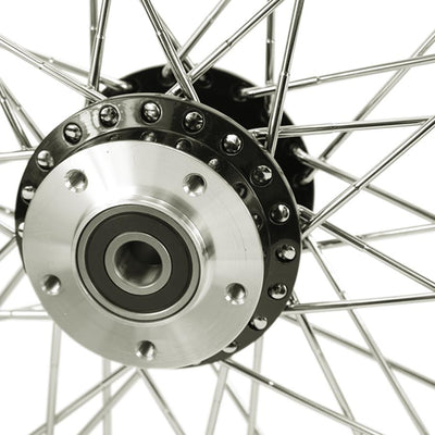 A close up image of a Moto Iron® Black Front 40 Spoke Wheel 19 "x 2.15" (fits Harley FXD 2000-03,Sportster 2000-07) Billet Hub on a Harley FXD motorcycle.