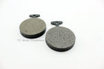 Two black Yamaha XS650 EBC Front Brake Pads (Fits 72-76 XS XS2 TX) on a white surface.