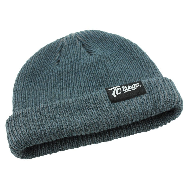 A blue TC Bros. Watchman Beanie - Steel, made of acrylic and featuring a logo on it.