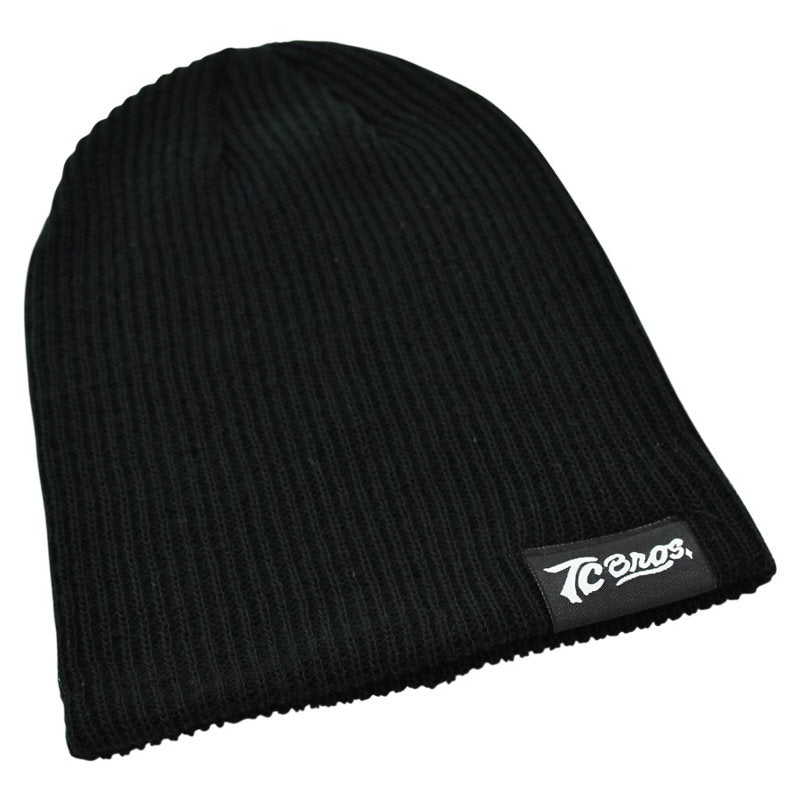 A ribbed knit TC Bros. Slouch Beanie - Black with a sewn-on clip label.